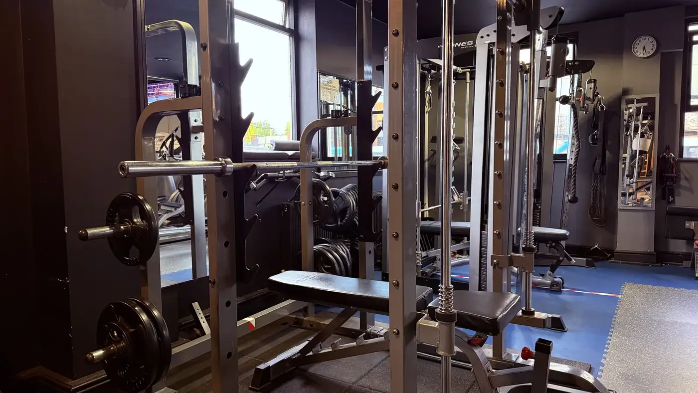 Strength training racks inside ACES Gym
